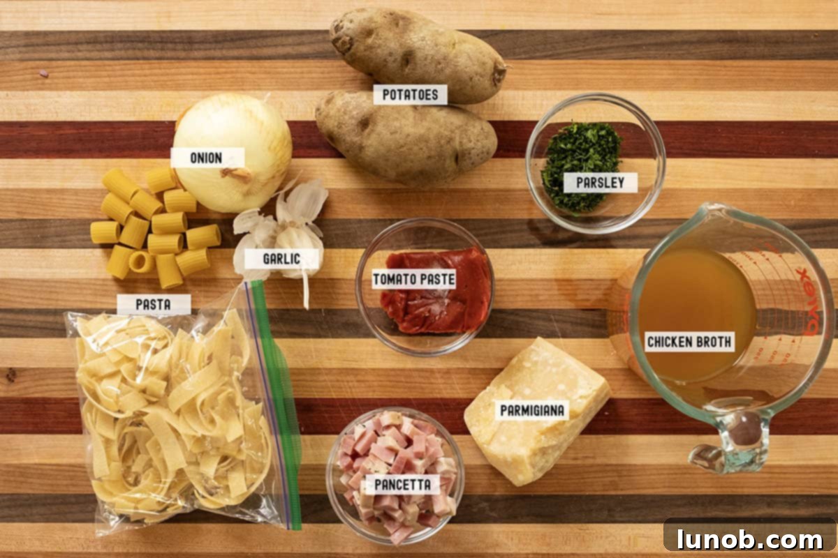 A collection of fresh ingredients laid out for the Pasta and Potatoes recipe, including potatoes, pasta, pancetta, and herbs.