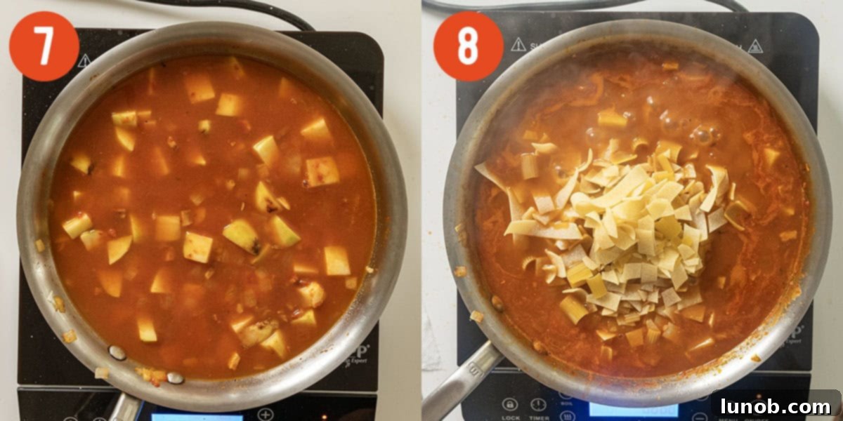 Potatoes, broth, and water simmering in a saucepan before adding pasta.