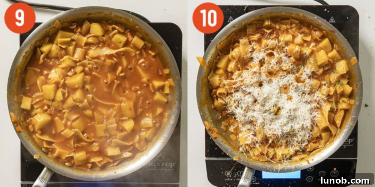 The finished Pasta and Potatoes simmering, with a rich, creamy sauce and grated Parmesan.