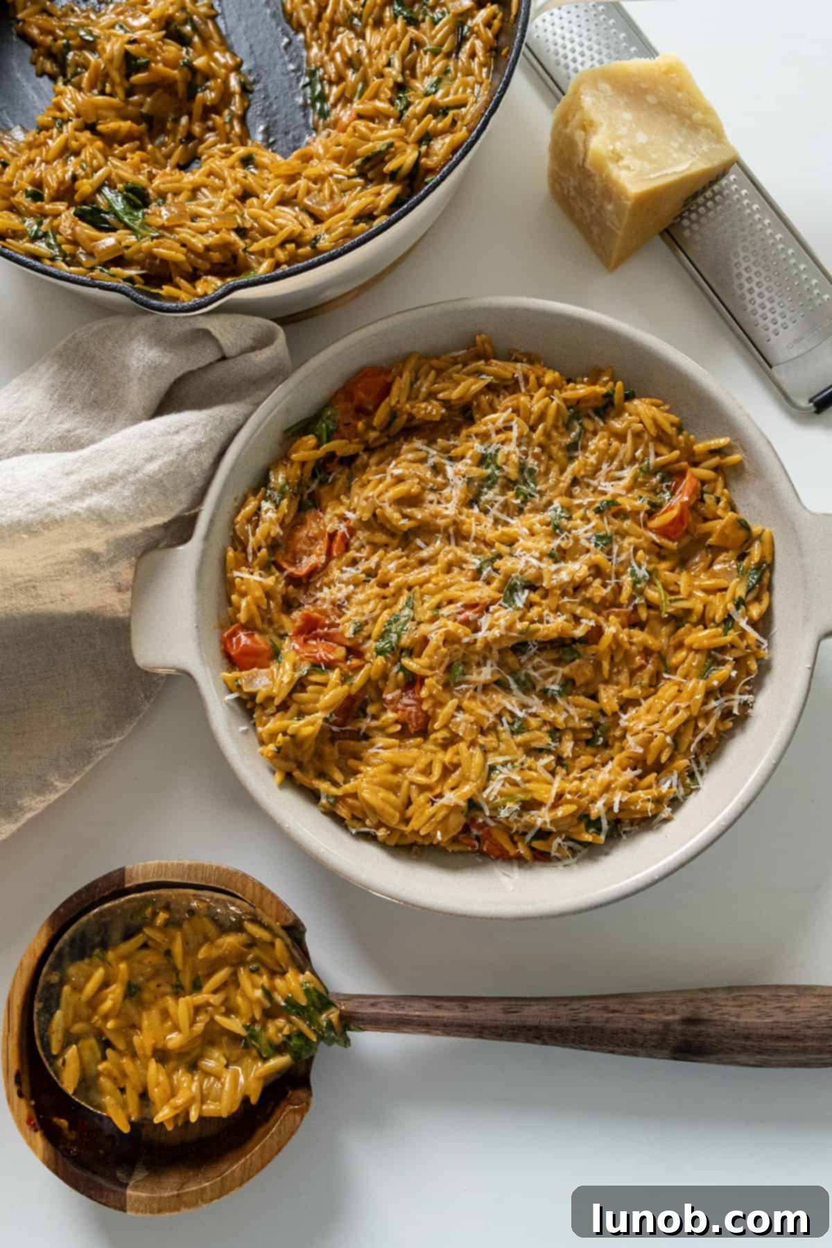 A generous serving of creamy tomato orzo in a decorative bowl, ready to be enjoyed.