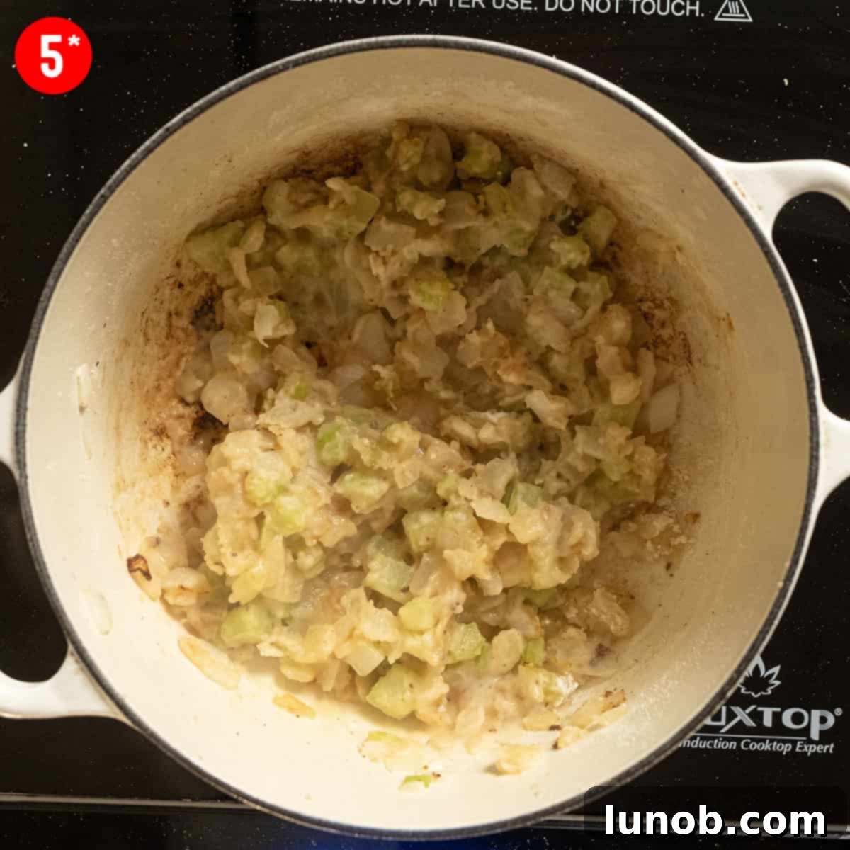 Velvet Clam Delight 6 Close-up of flour and wine combining with sautéed vegetables to form a paste.