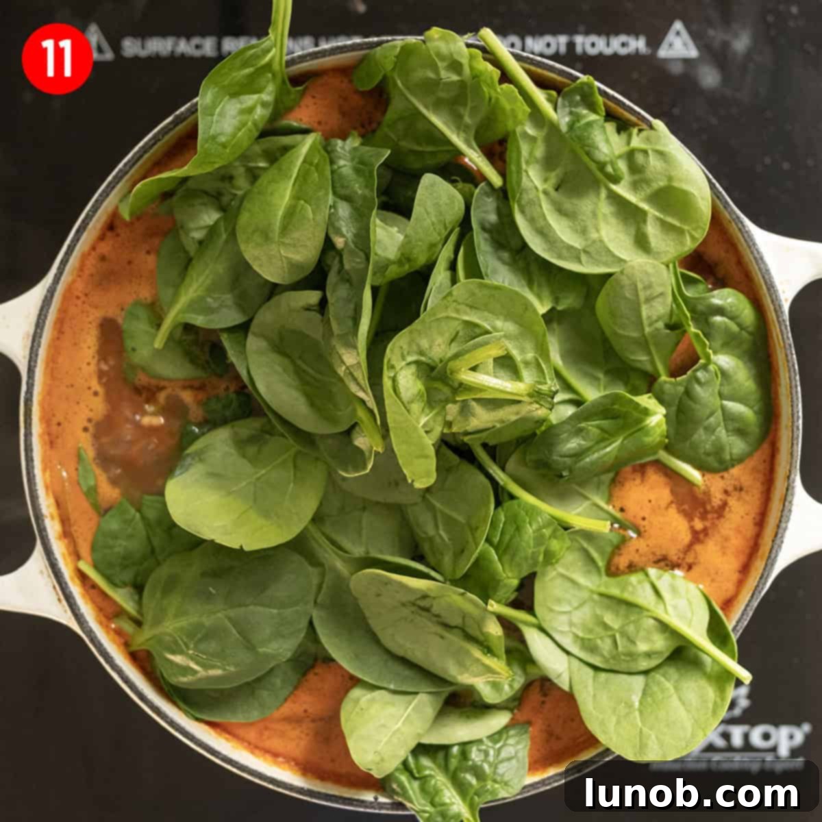 Wilting spinach in clam chowder soup.