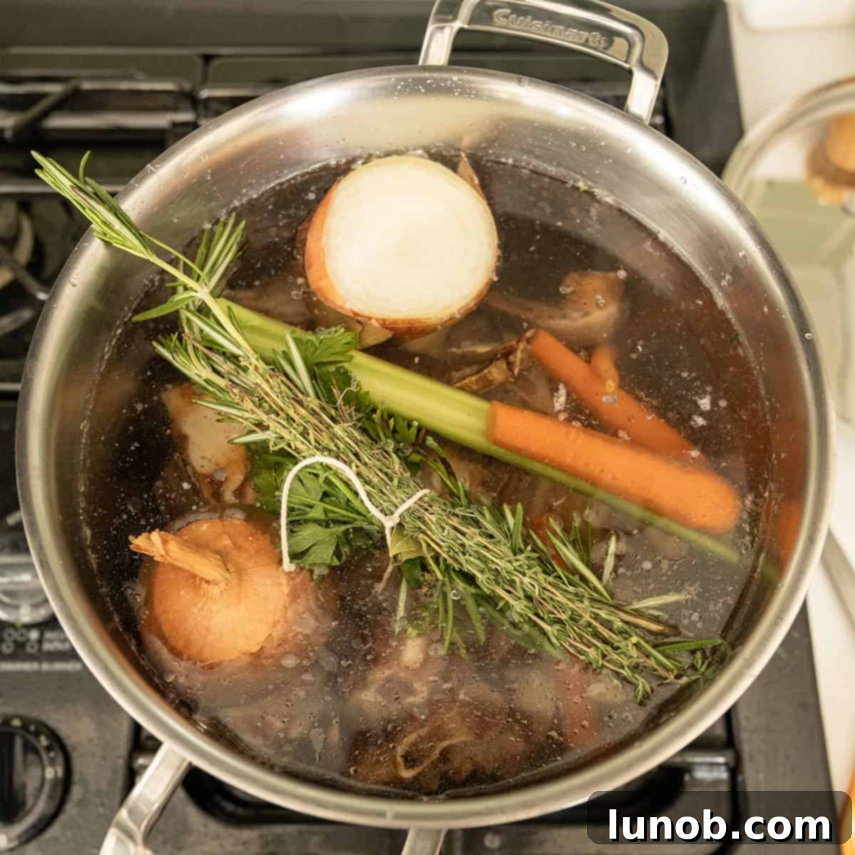 Simmering beef and vegetables in a pot.