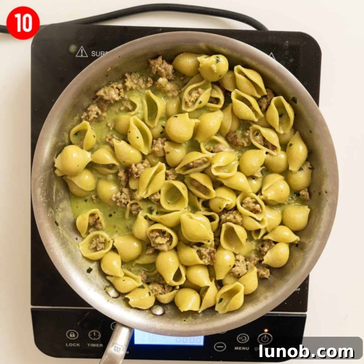Kale and walnut pesto with shell pasta in a bowl.