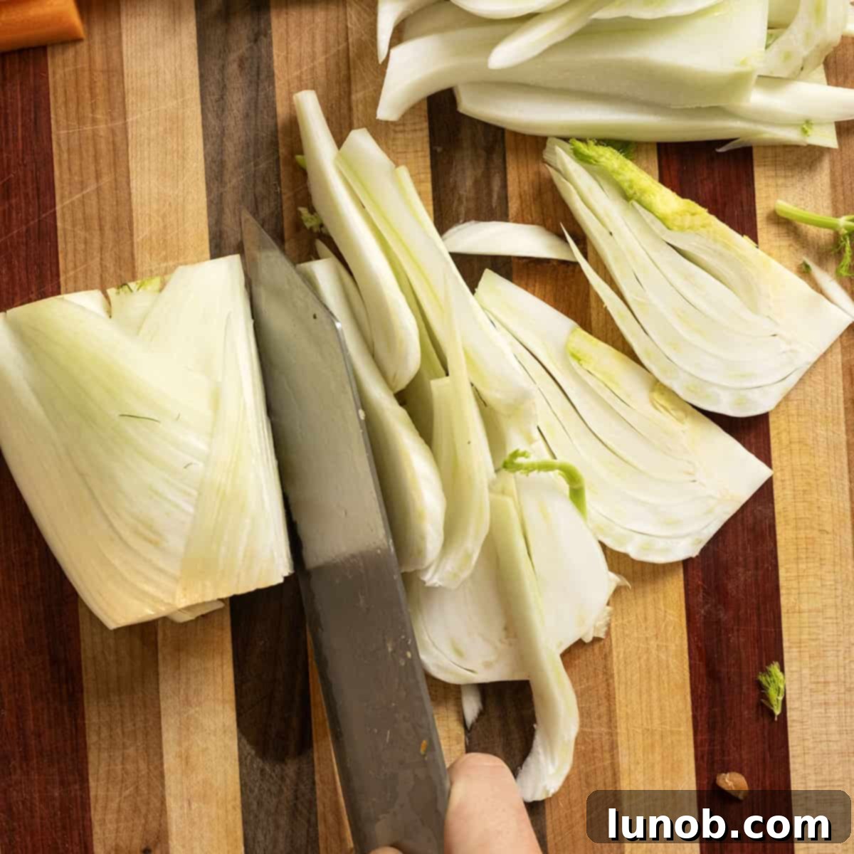 Sweet and Earthy Roasted Carrots and Fennel 4 Slice fennel on a cutting baord.