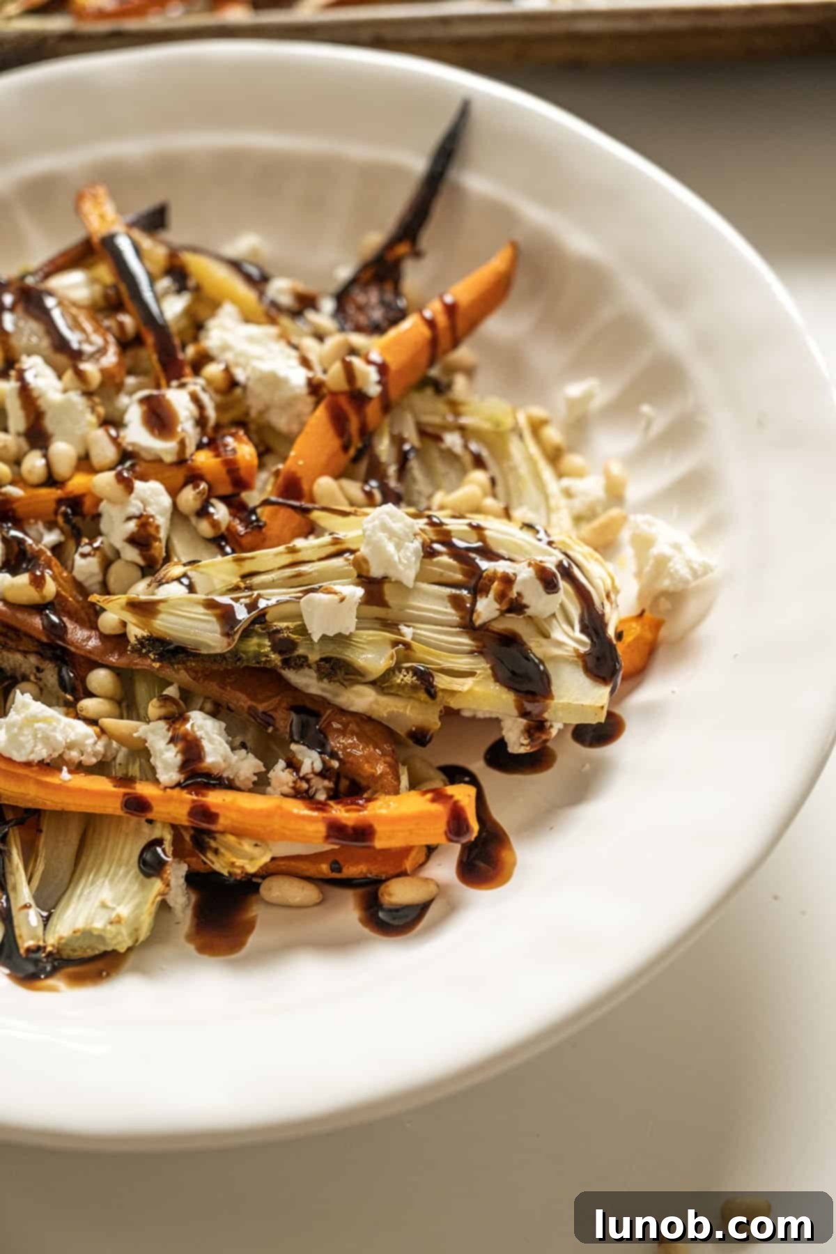 Sweet and Earthy Roasted Carrots and Fennel 10 Roasted Carrots and fennel topped with pine nuts and balsamic glaze.
