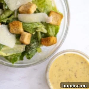 A bowl of creamy homemade Traditional Caesar Dressing.