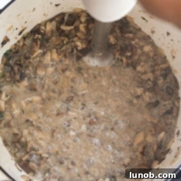 Blending the soup directly in the pot with an immersion blender.