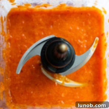 Smooth, blended roasted red pepper puree in a blender.