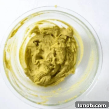 The fluffy egg yolk and sugar mixture being carefully folded into the pistachio and mascarpone blend.