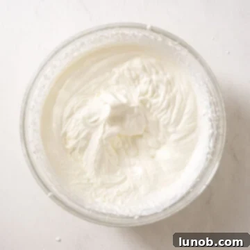 Heavy cream beat to stiff peaks, forming a stable, airy texture.