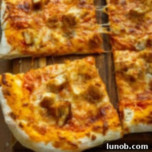 Pizza cut into slices on the cutting board.