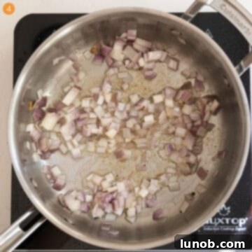 Minced shallots sautéing in the same saucepan with pancetta fat.