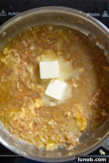 Gourmet Chicken Francese 12 Unsalted butter, fresh basil, and chopped parsley being stirred into the finished lemon-wine sauce off the heat for richness and aroma.