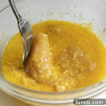 Gourmet Chicken Francese 5 A bowl containing beaten eggs, freshly grated parmesan cheese, and salt, ready for dipping chicken.