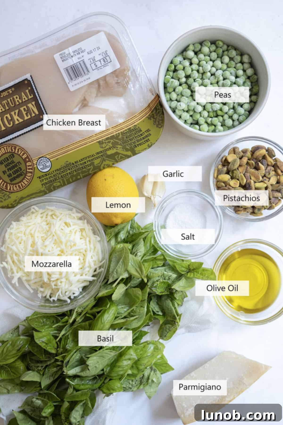 Irresistible Pesto Stuffed Chicken 3 Key ingredients for the pesto stuffed chicken recipe laid out on a table.