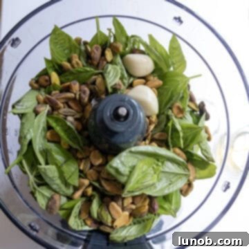 Irresistible Pesto Stuffed Chicken 4 Ingredients for pesto in a food processor, ready to be blended.