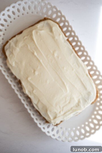 cream cheese frosting spread on carrot cake blondies