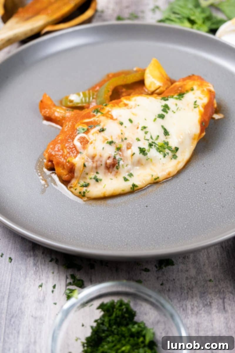 Ultimate Chicken Pizzaiola 12 Close-up of golden-brown Chicken Pizzaiola with vibrant peppers and garlic in a rich tomato sauce, ready to serve.