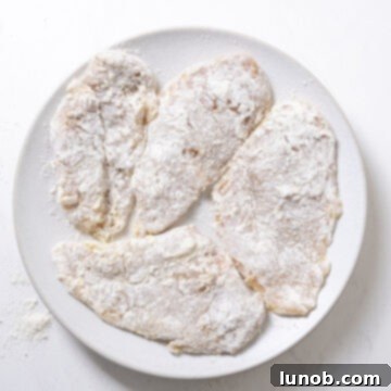 Ultimate Chicken Pizzaiola 5 Chicken breasts lightly dredged in all-purpose flour, preparing for frying.