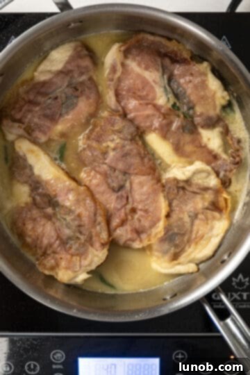 finishing chicken in the pan with the sauce