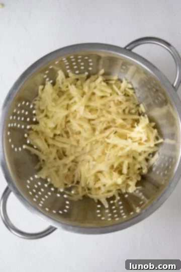 Grated potatoes in a colander