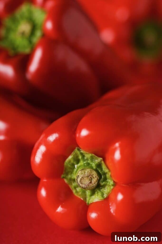 Perfectly Roasted Red Peppers: Freeze for Future Flavor 5 A collection of roasted red peppers, some whole and some peeled, in varying shades of red and char