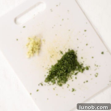 Fresh Avocado Lime Crema 5 Minced garlic and cilantro on a cutting board.