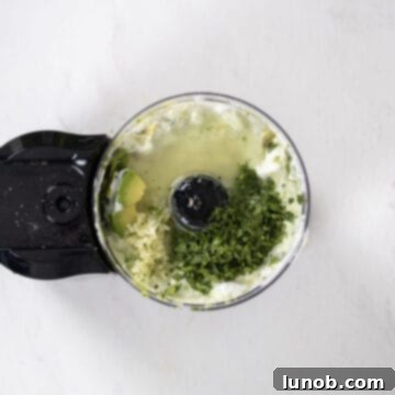 Fresh Avocado Lime Crema 7 cilantro, garlic, and lime juice added to the food processor.