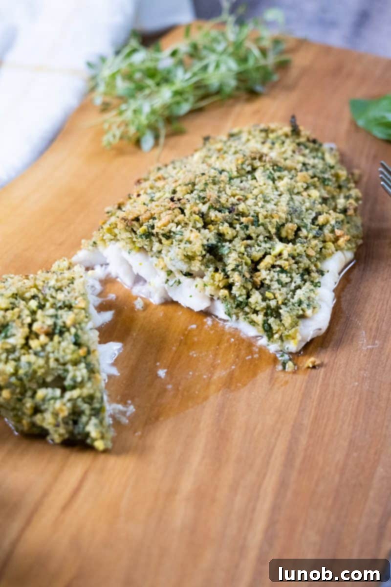 Golden Pistachio-Crusted Fish 2 Pistachio Crusted Fish with fresh herbs, elegantly plated.
