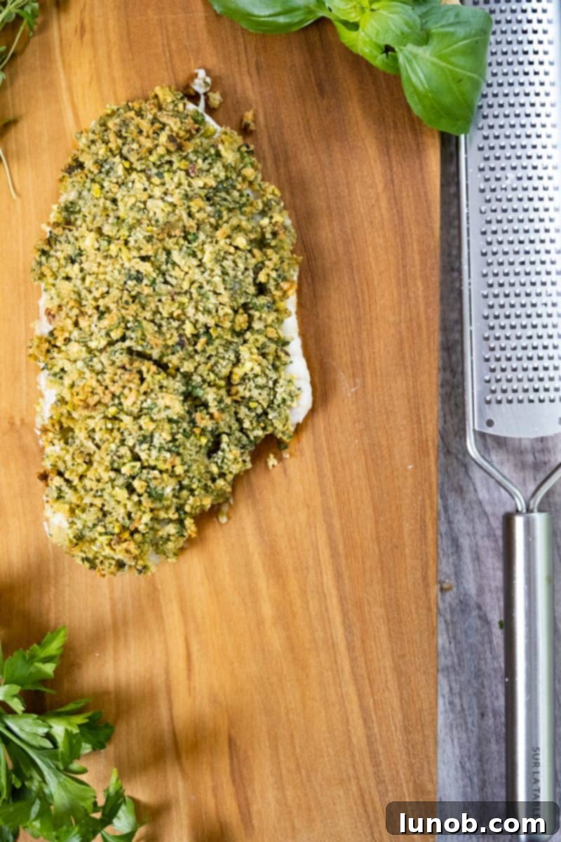 Golden Pistachio-Crusted Fish 3 Close-up of pistachio crusted fish, showcasing the vibrant green crust.