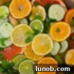 Close-up of spa water with citrus, cucumber, and herbs.