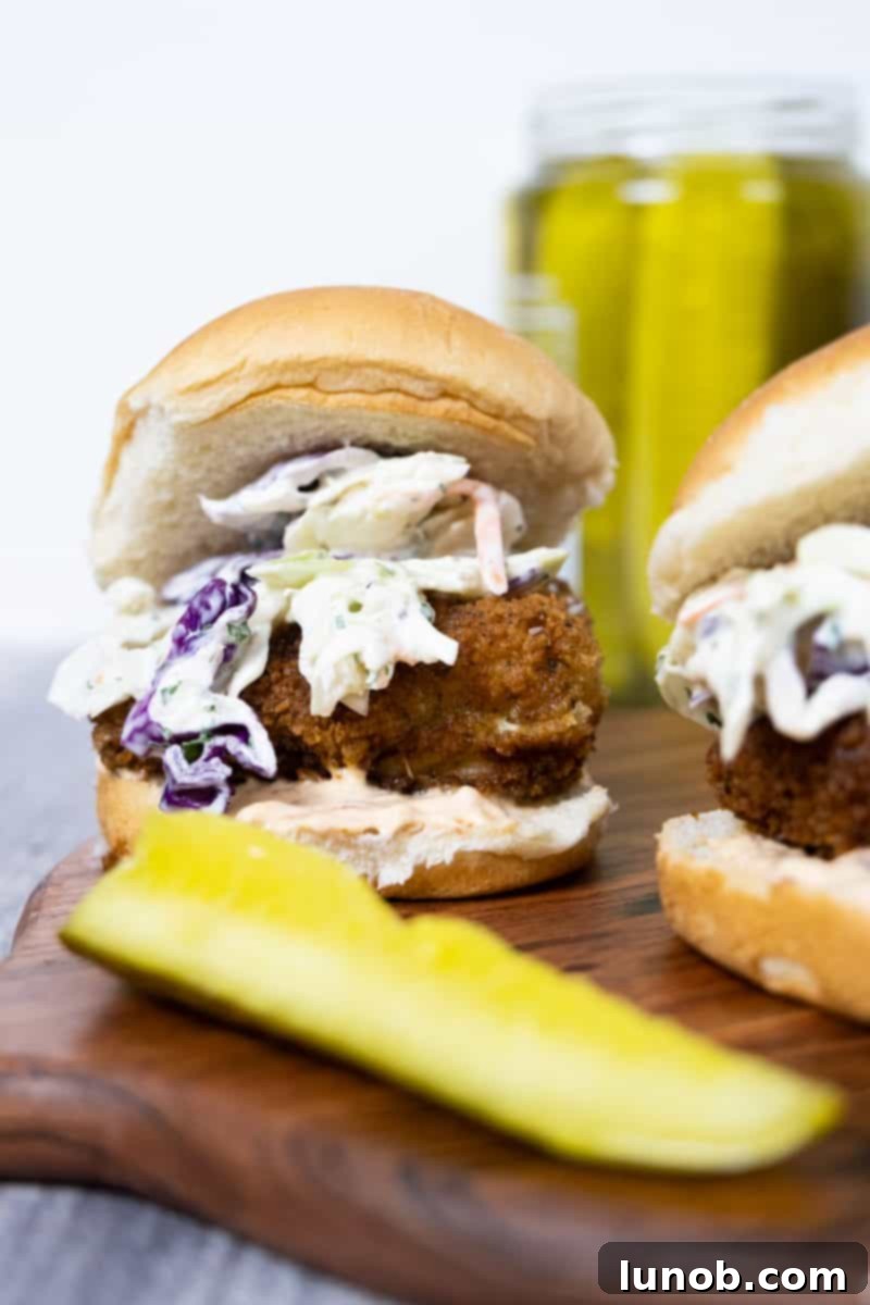 Crunchy Catch Sliders 2 Crispy fish slider with a generous topping of coleslaw and a drizzle of chipotle mayo, served with a side of pickle slices