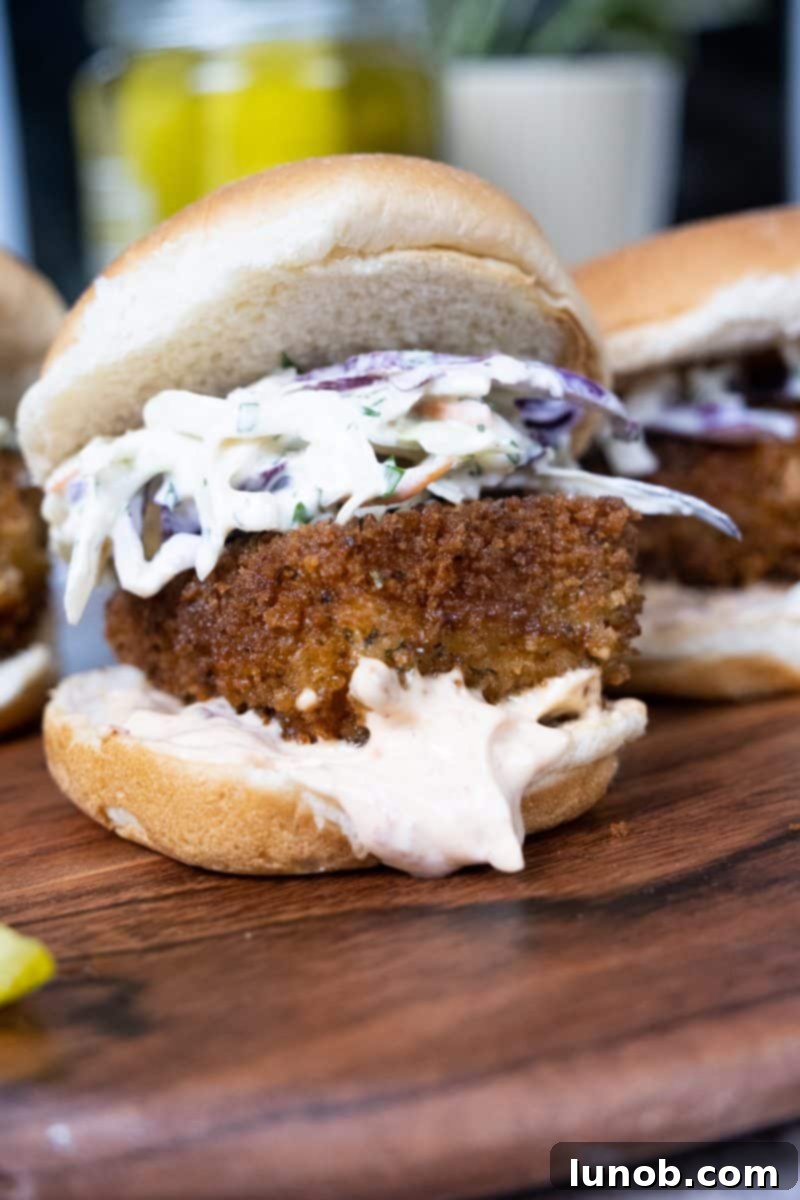 Crunchy Catch Sliders 4 Crispy fish slider with chipotle mayo and coleslaw, showcasing the golden fried fish and fresh ingredients