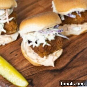 Crispy fish slider with coleslaw and chipotle mayo on a white bun