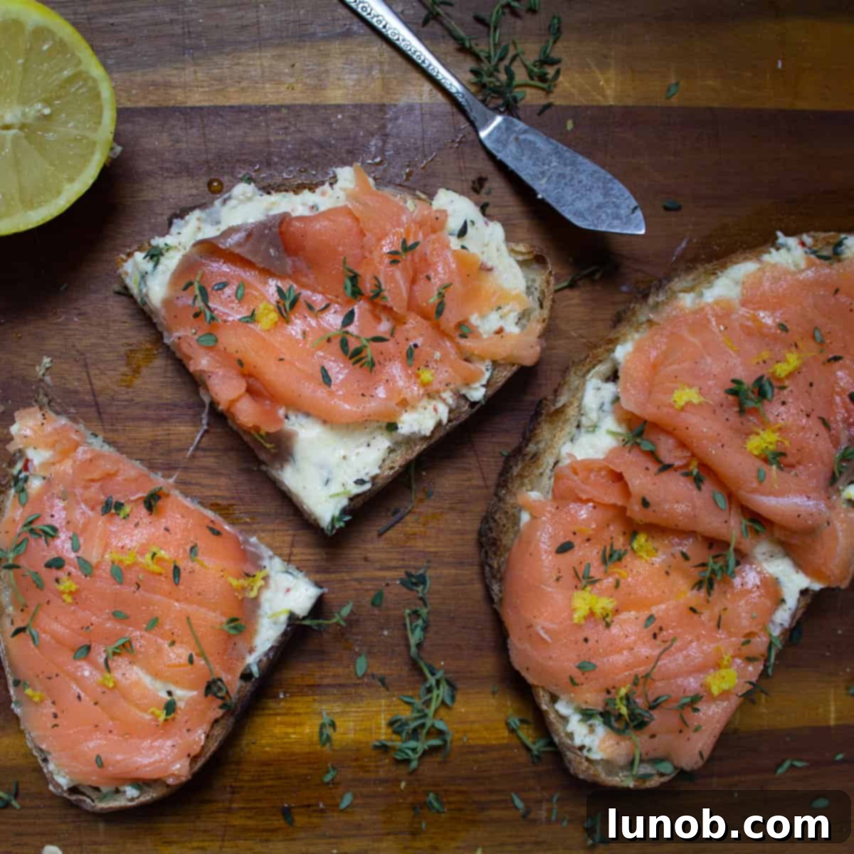 Delicate Mascarpone Toast with Lox, garnished with fresh herbs and lemon zest, ready for a gourmet brunch.