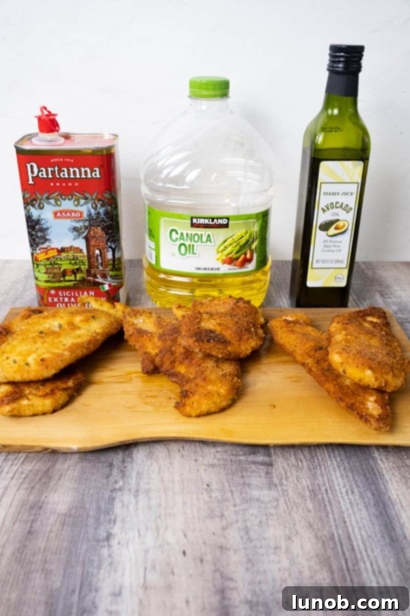 Golden Cutlets The Right Oil for Frying 2 Three golden-brown chicken cutlets, each fried in a different oil, resting on a serving platter.