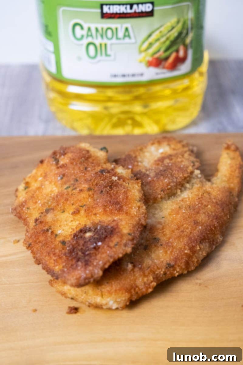 Golden Cutlets The Right Oil for Frying 11 A chicken cutlet fried in canola oil, showcasing its cooked appearance.