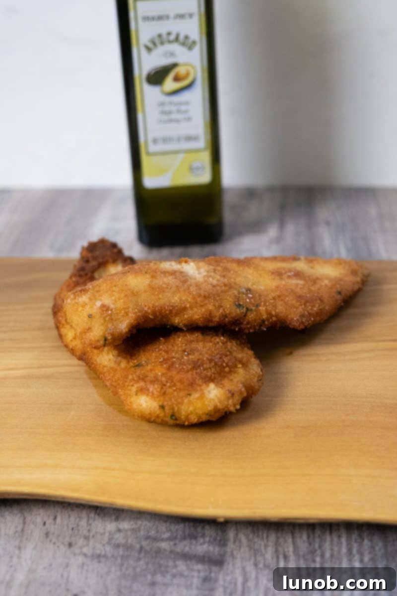 Golden Cutlets The Right Oil for Frying 10 A close-up of a chicken cutlet fried in avocado oil, showing its golden crisp exterior.