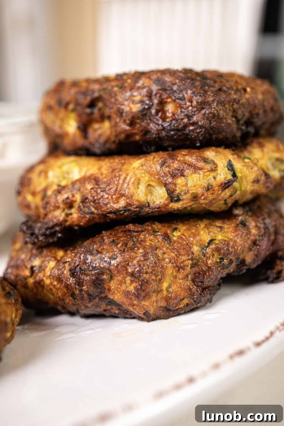 Crispy Air-Fried Zucchini Fritters 11 A stunning plate of air fryer zucchini fritters, garnished and ready to be served.