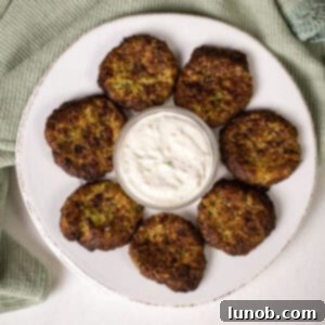 Air fryer zucchini fritters on a plate with aioli.