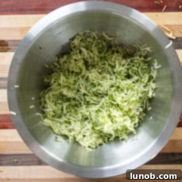 Crispy Air-Fried Zucchini Fritters 5 Grated zucchini collected in a bowl, ready for draining.