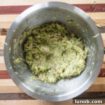 Crispy Air-Fried Zucchini Fritters 8 The zucchini fritter mixture thoroughly mixed in a bowl, showing the correct consistency.