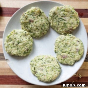 Crispy Air-Fried Zucchini Fritters 9 Zucchini fritter mixture shaped into uniform patties, ready for air frying.