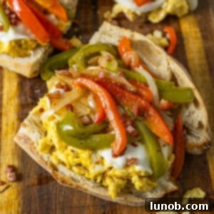Peppers and eggs sandwich with mozzarella and pancetta on Italian Bread.