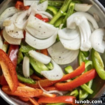 Classic Pepper & Egg Sub 6 raw peppers and onions sauteing in a frying pan.