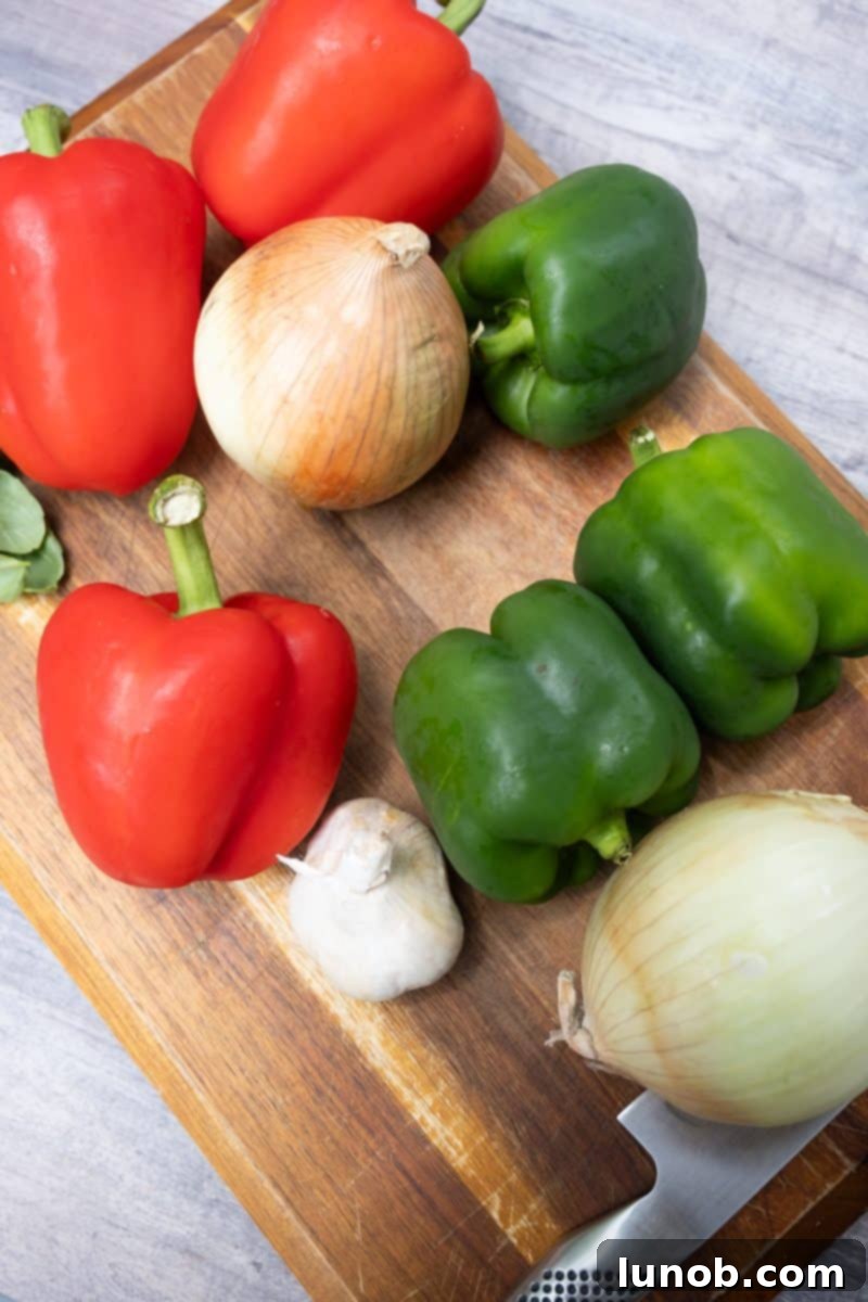 Rustic Italian Sausage Skillet 3 Freshly sliced peppers, onions, whole garlic cloves, and basil leaves