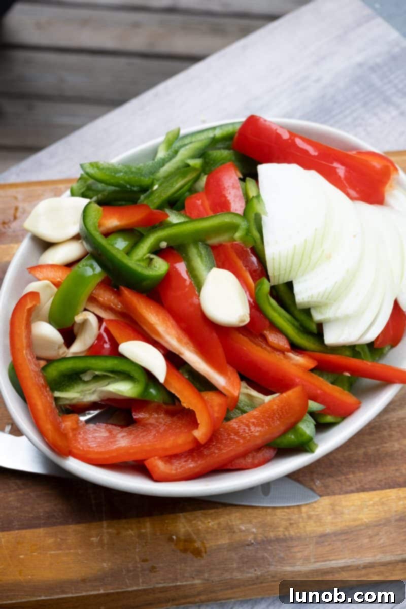 Rustic Italian Sausage Skillet 4 Sautéing peppers, onions, and garlic in a cast iron pan on the grill