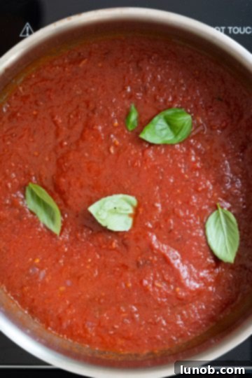 Fiery Fra Diavolo Shrimp Linguine 9 Crushed tomatoes and fresh basil leaves added to the simmering red sauce, infusing it with vibrant flavor.