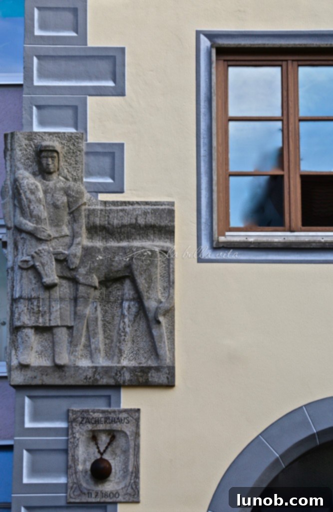 Ornate building facade featuring religious statuary and intricate details in Landshut